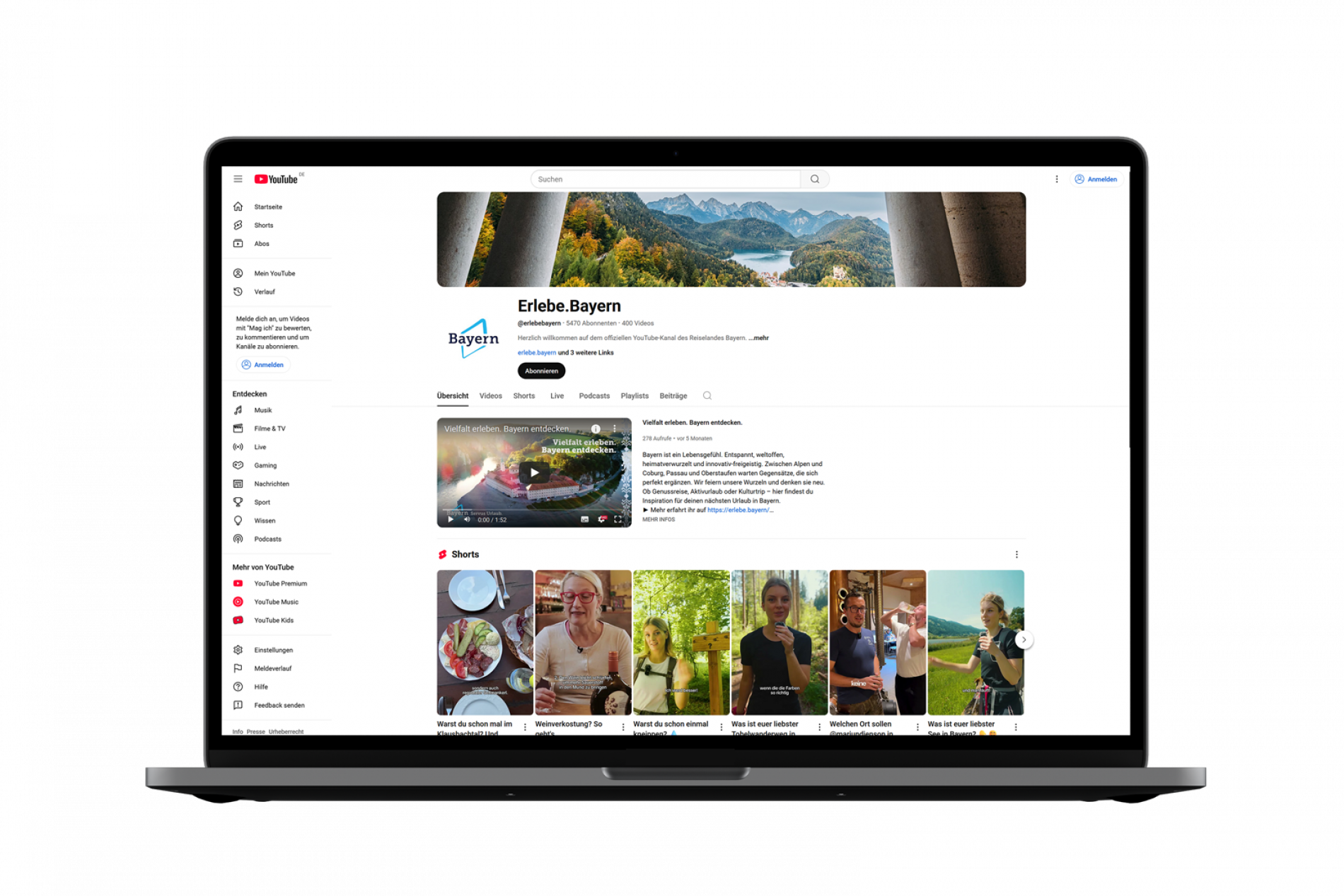 BayTM YourTube Kanal MacBook Pro zeigt YouTube-Kanal Erlebe.Bayern mit Banner, Kanalname, Logo und Video-Vorschau.